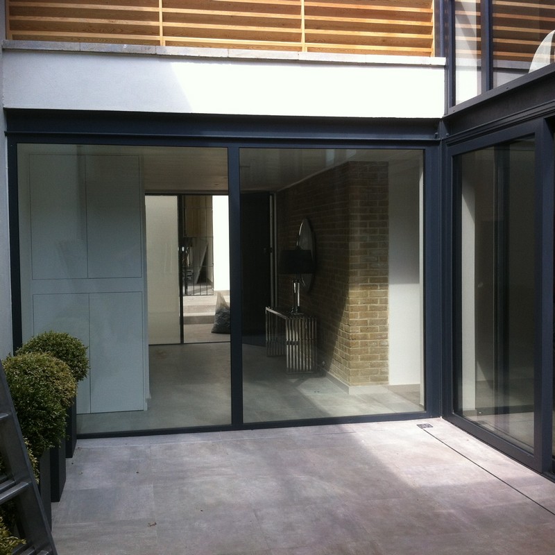 Floor-to-ceiling sliding doors opening to courtyard in Leighton Buzzard