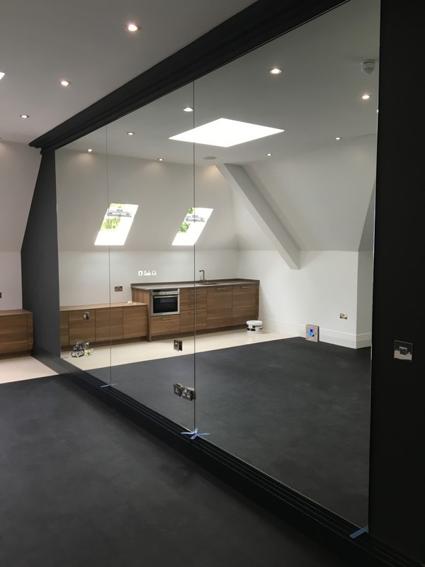 Frameless glass partition in loft conversion by Leighton Buzzard glaziers