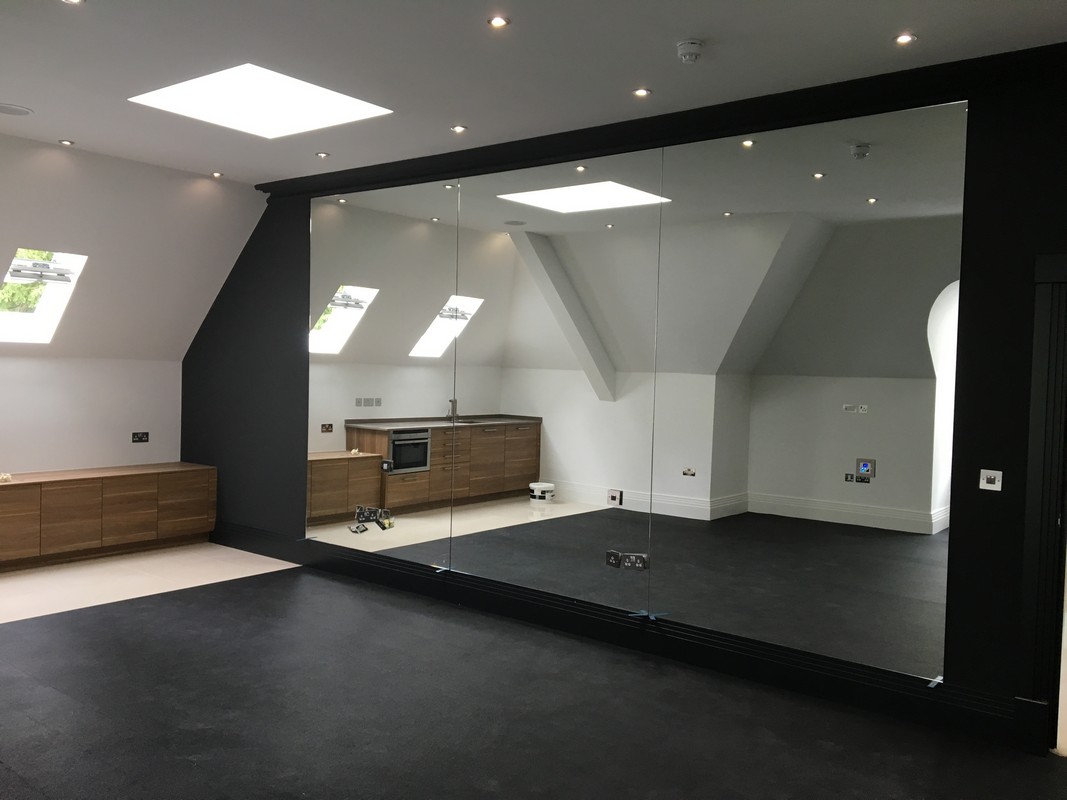 Frameless glass wall dividing loft conversion in Leighton Buzzard
